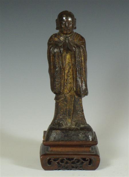 Appraisal: A Chinese bronze standing figure of a Buddhist monk in