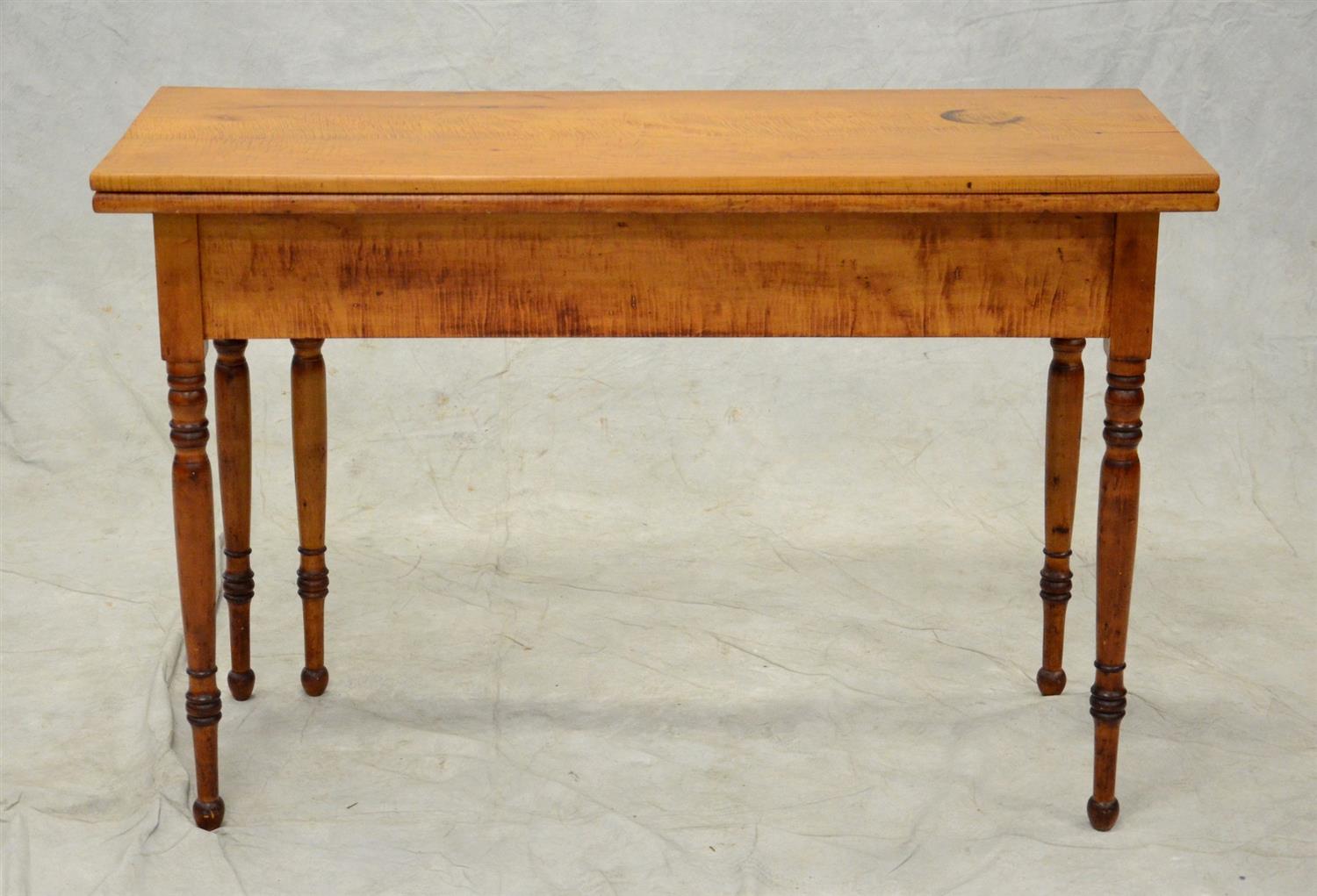 Appraisal: Figured maple Sheraton console table with fold over top swing