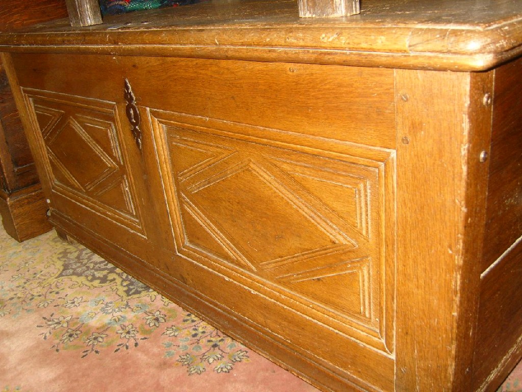 Appraisal: An antique oak coffer with lozenge shaped panels and iron