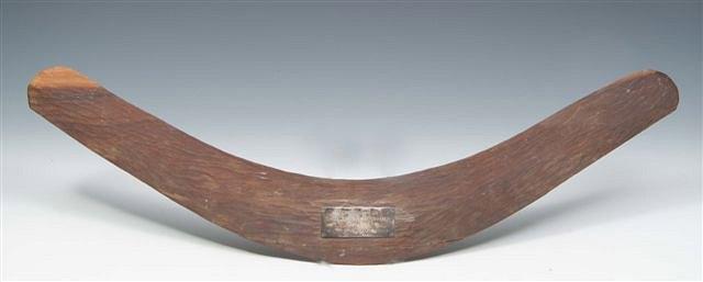 Appraisal: An Australian Aboriginal wooden boomerang with silver presentation plaque inscribed