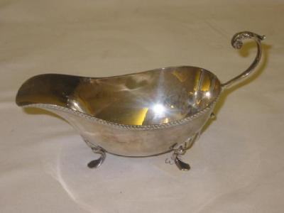 Appraisal: A SAUCE BOAT of oval form with leaf capped flying