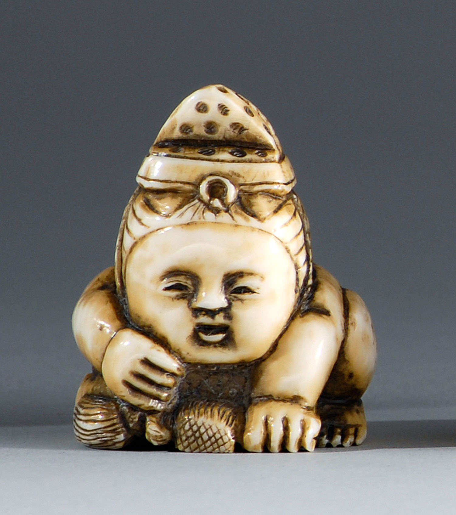 Appraisal: IVORY NETSUKE Meiji PeriodIn the form of a karako holding