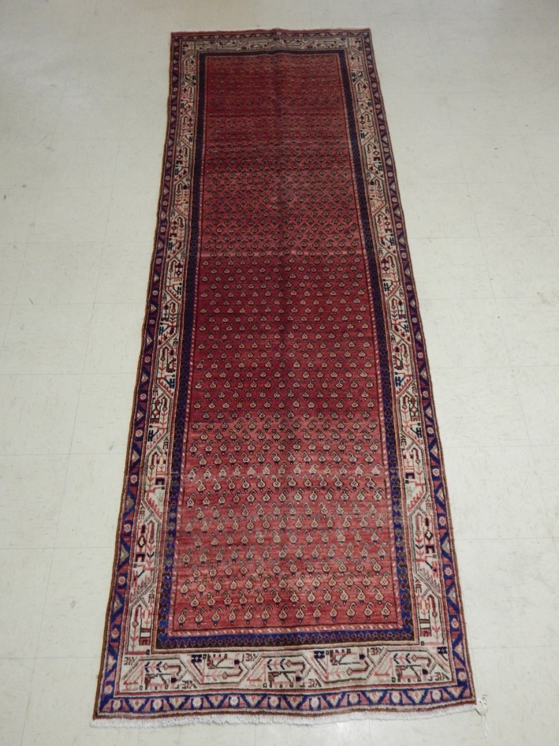 Appraisal: A Persian Sarouk runner with an all over design of