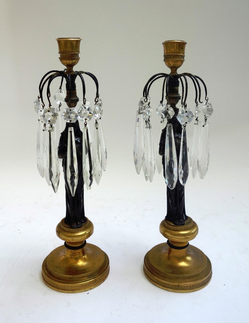 Appraisal: A pair of patinated and gilt bronze figural candlestick lustres