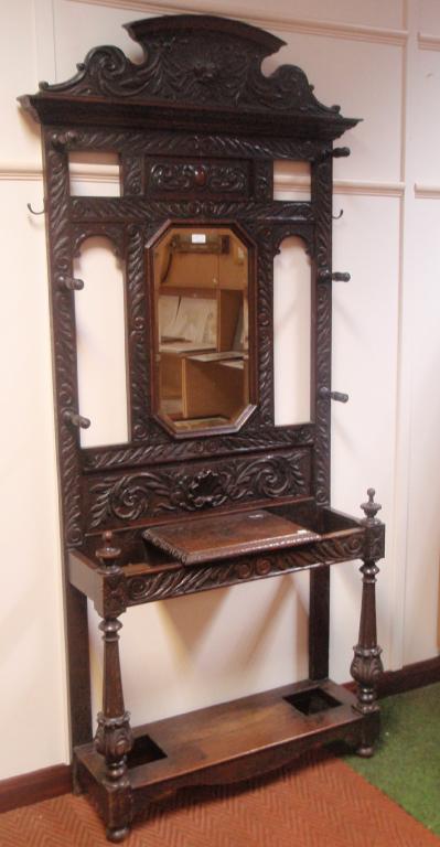 Appraisal: A Victorian carved oak hall stand with mirror back shell