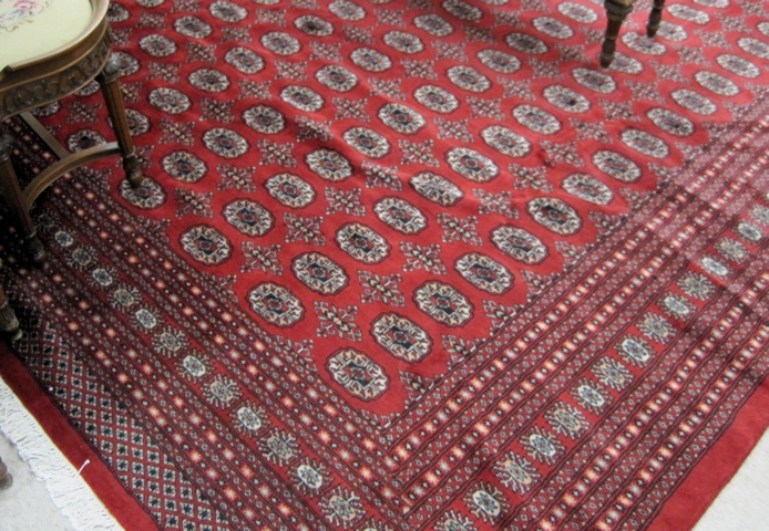 Appraisal: PAKISTANI BOKHARA CARPET repeating columns of Turkoman gols on red