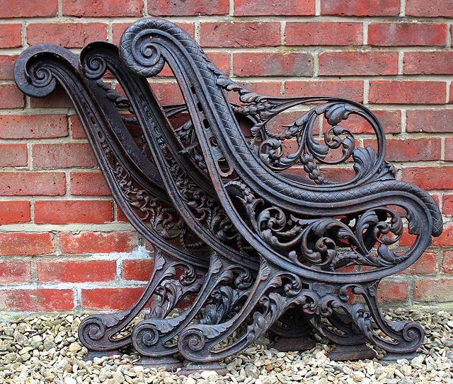 Appraisal: A VICTORIAN CAST IRON BENCH FRAME of scrolling form decorated