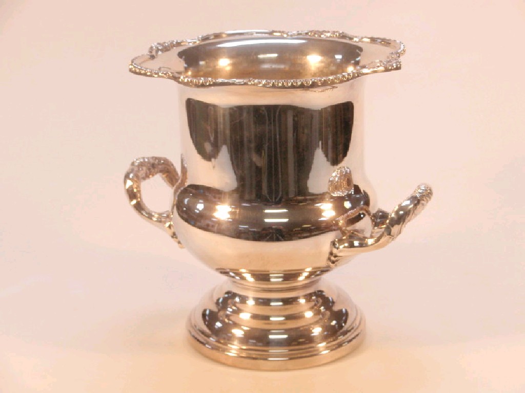 Appraisal: An electroplated two-handled campana shaped ice bucket the everted rim