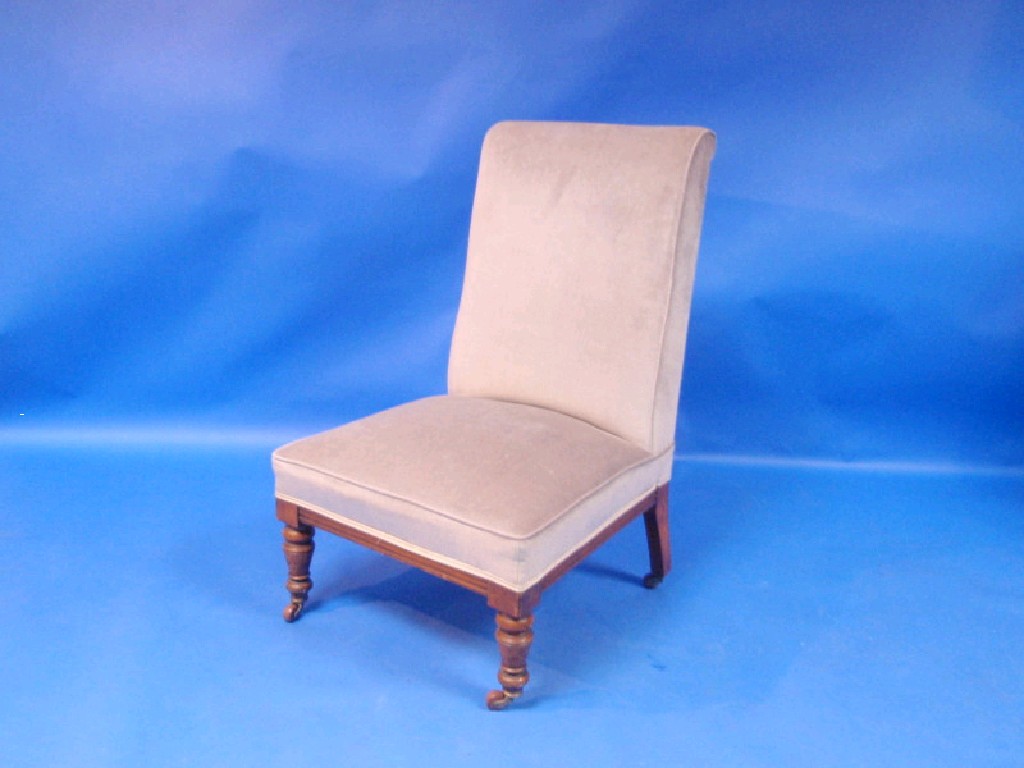 Appraisal: A late Victorian oak-framed low seated upholstered chair with slightly