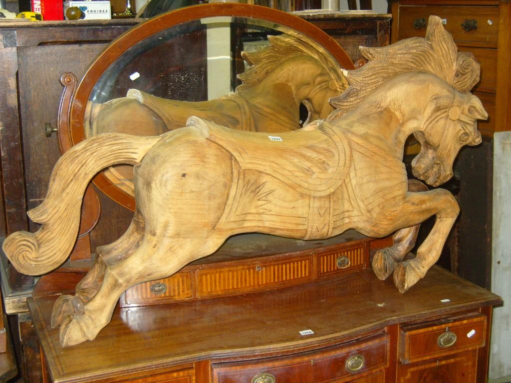 Appraisal: A carved pine carousel horse with flowing mane