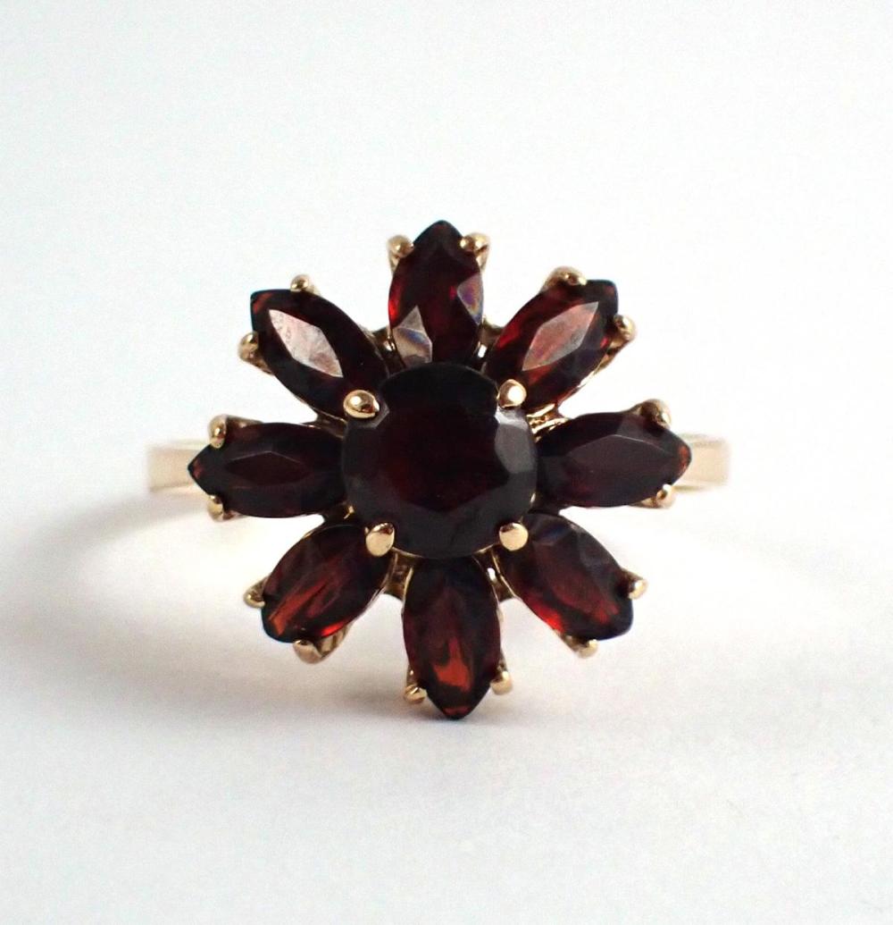 Appraisal: ITALIAN MADE GARNET AND EIGHTEEN KARAT GOLD RING with eight