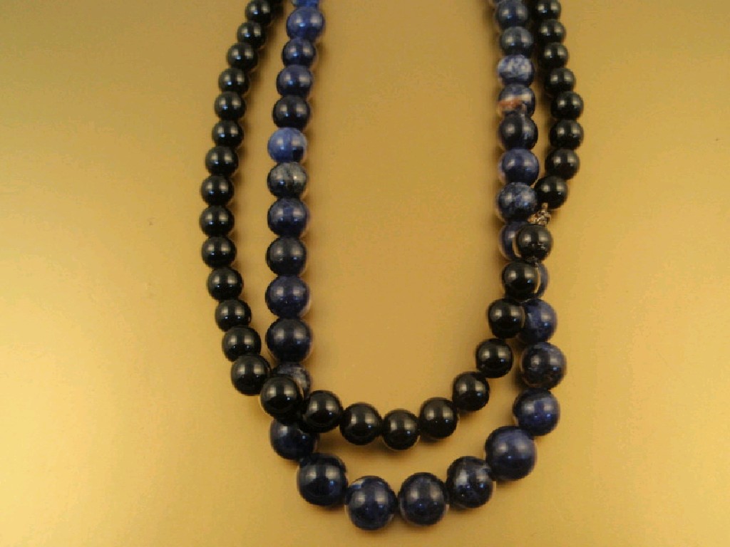 Appraisal: A sodalite bead necklace with matching stud screw back earrings