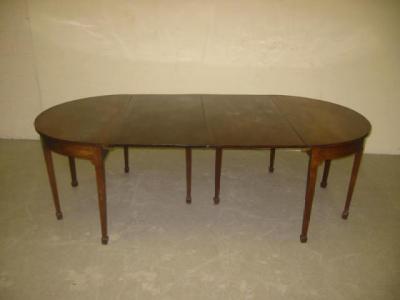 Appraisal: A GEORGE III MAHOGANY DINING TABLE of rounded oblong drop