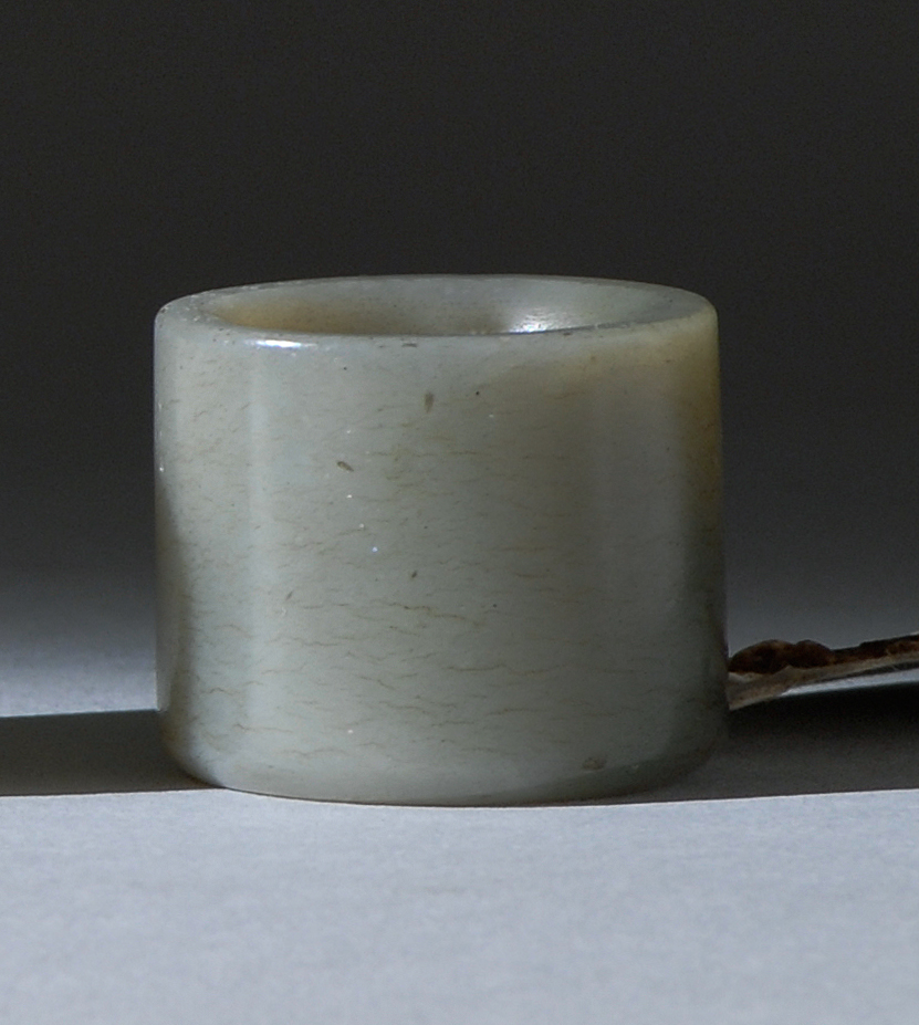 Appraisal: LIGHT GRAY AND PALE CELADON JADE ARCHER'S RING Early th