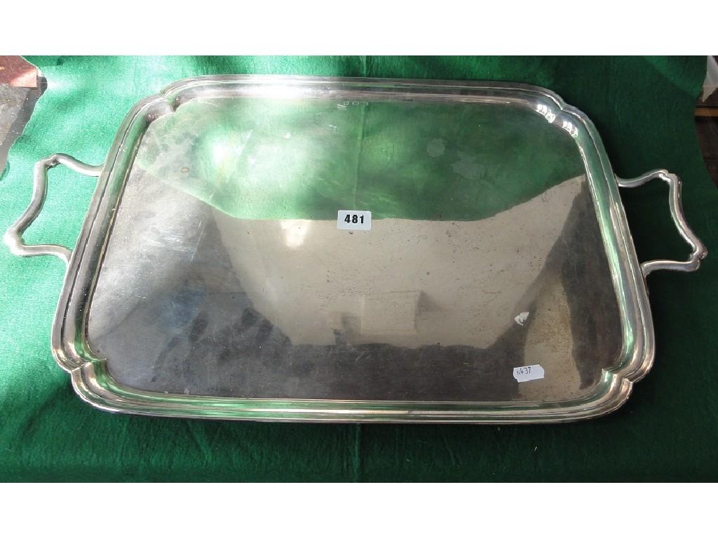 Appraisal: A large silver double handled drinks tray with shaped corners