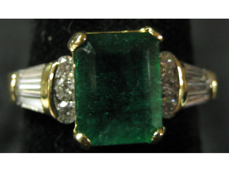 Appraisal: EMERALD AND DIAMOND RING k yellow gold ring set with