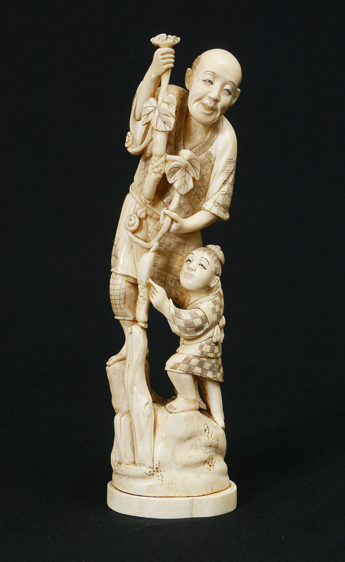 Appraisal: CARVED IVORY FIGURAL GROUP FARMER BOY Figure of a man