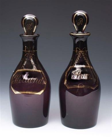 Appraisal: A PAIR OF AMETHYST GLASS DECANTERS WITH STOPPERS marked in