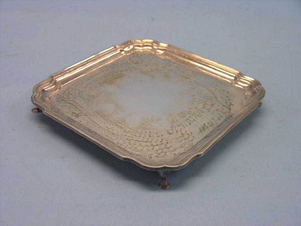 Appraisal: A silver card tray square-shape with re-entrant corners on four