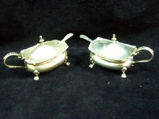 Appraisal: A pair of mustards with gadrooned rims on scroll legs