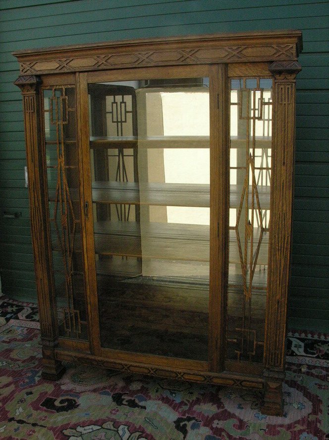 Appraisal: CARVED AMERICAN OAK CHINA CABINET oak interior shelves mirror back