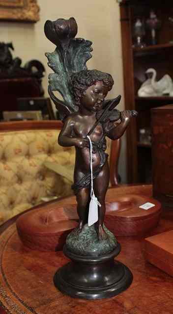 Appraisal: A BRONZE STATUE OF CUPID playing a violin on a