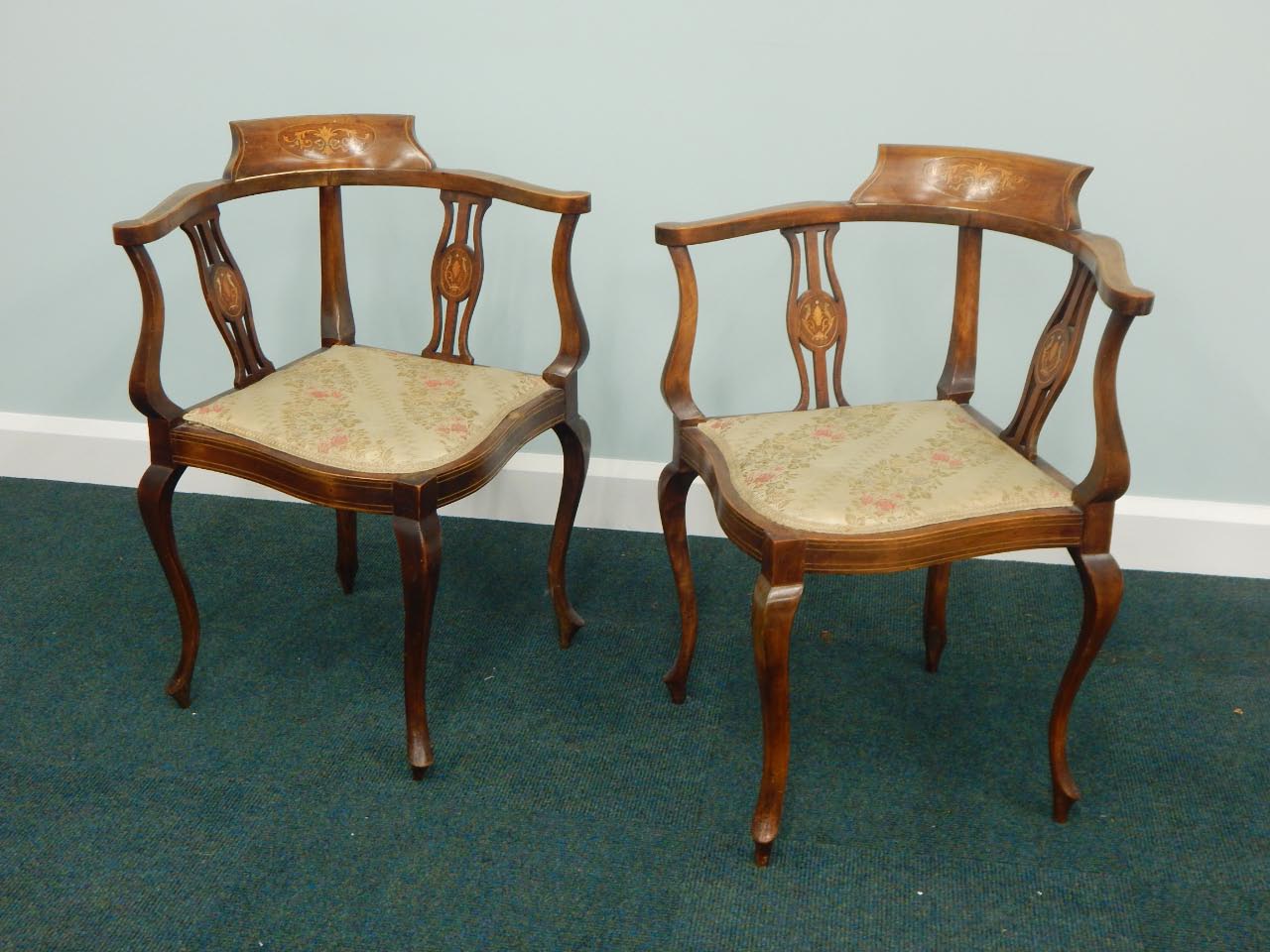 Appraisal: A pair of Edwardian mahogany and marquetry corner chairs each