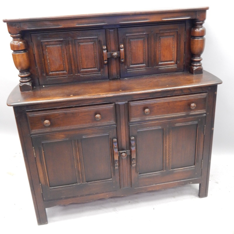 Appraisal: An Ercol dark elm court cupboard the raised back with