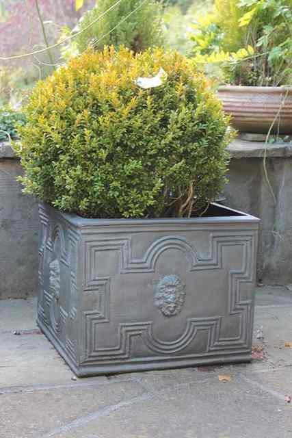 Appraisal: A SET OF FOUR COMPOSITE FAUX LEAD SQUARE PLANTERS with