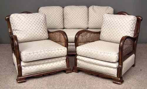 Appraisal: A s walnut framed and caned three piece Bergere suite