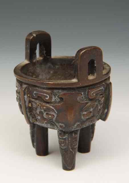 Appraisal: A CHINESE MINIATURE BRONZE ARCHAIC STYLE CENSER late th Century