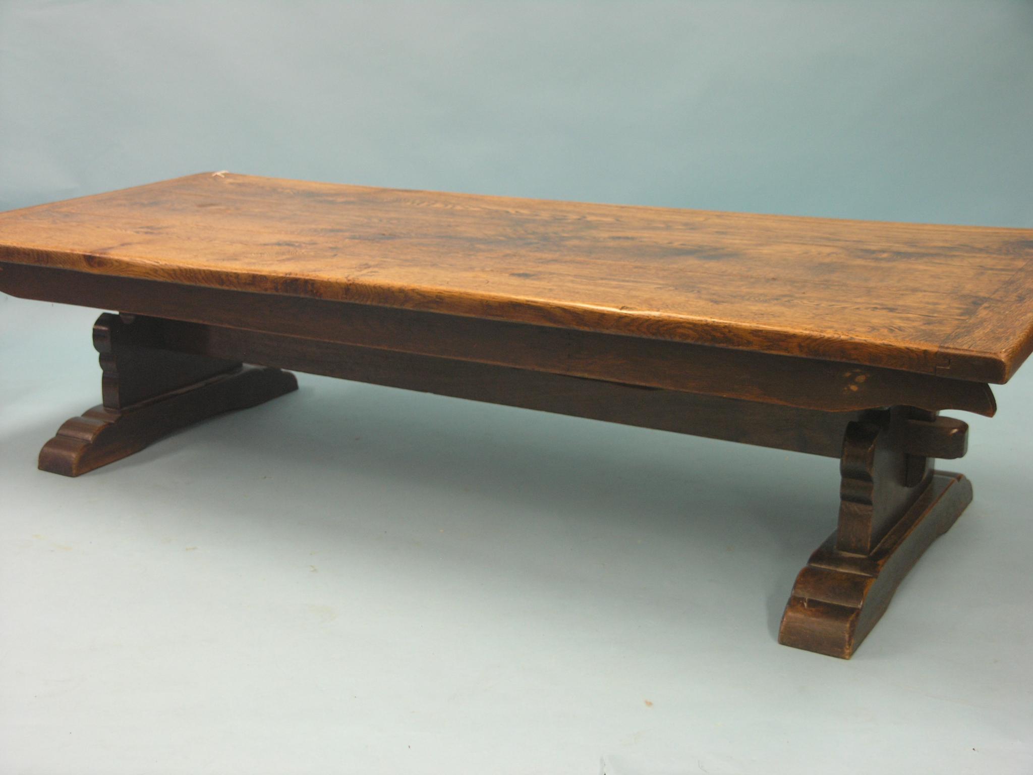 Appraisal: A solid dark oak coffee table three-plank top on shaped