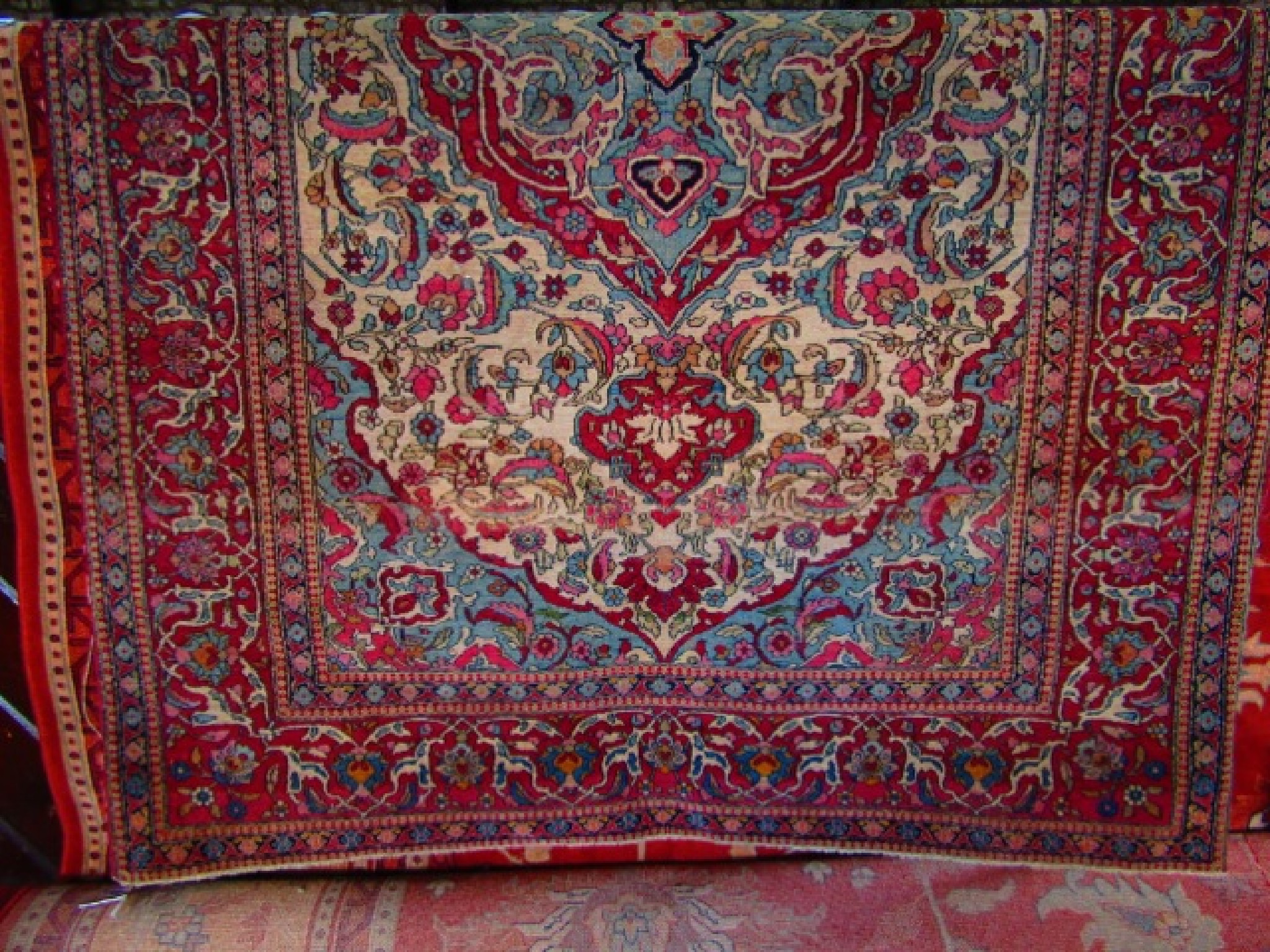 Appraisal: An eastern wool carpet with cream ground highly decorated in