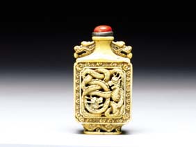 Appraisal: CARVED IVORY SNUFF BOTTLE Very elaborately carved Chinese ivory square-form