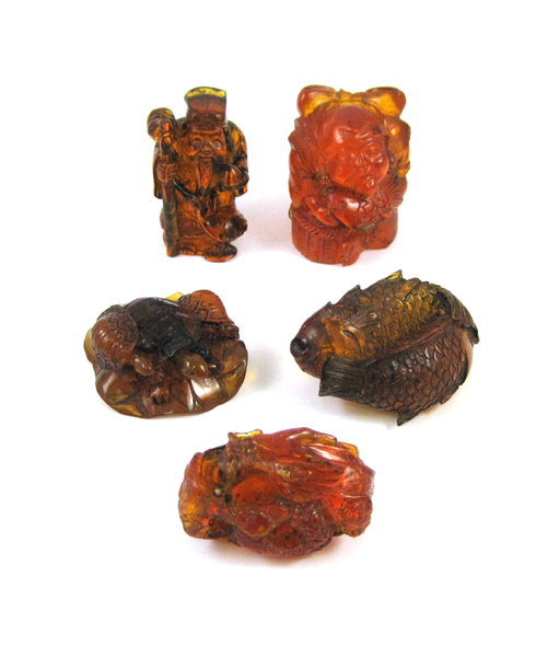 Appraisal: FIVE CHINESE ORANGE-RED AMBER CARVINGS including a man holding a