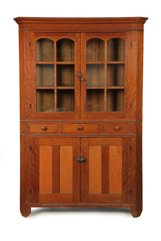 Appraisal: ONE PIECE CORNER CUPBOARD Flame grain cherry having a stepped