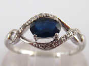 Appraisal: A white metal tests carat gold sapphire and diamond ring