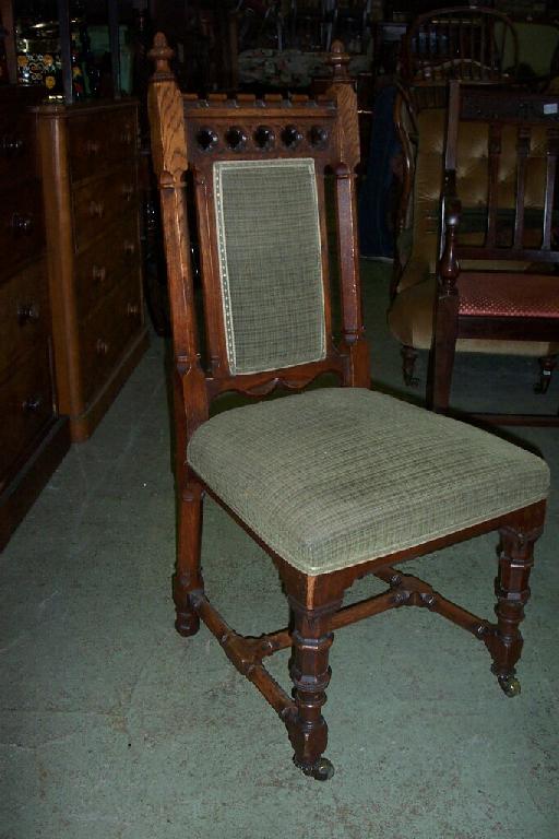 Appraisal: A set of eight Victorian gothic oak dining chairs with