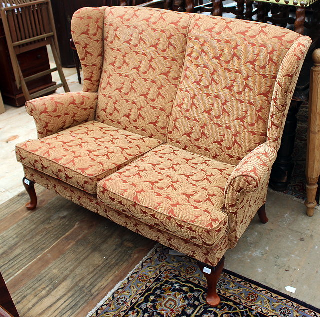 Appraisal: A PARKER KNOLL TWO SEATER WING BACK SETTEE