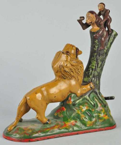 Appraisal: Cast Iron Lion Two Monkeys Mechanical Bank Description Working Manufactured