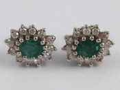 Appraisal: A pair of white metal tests carat gold emerald and