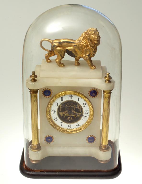 Appraisal: WHITE ONYX AND GILT-METAL MANTEL CLOCK with lion surmounting a