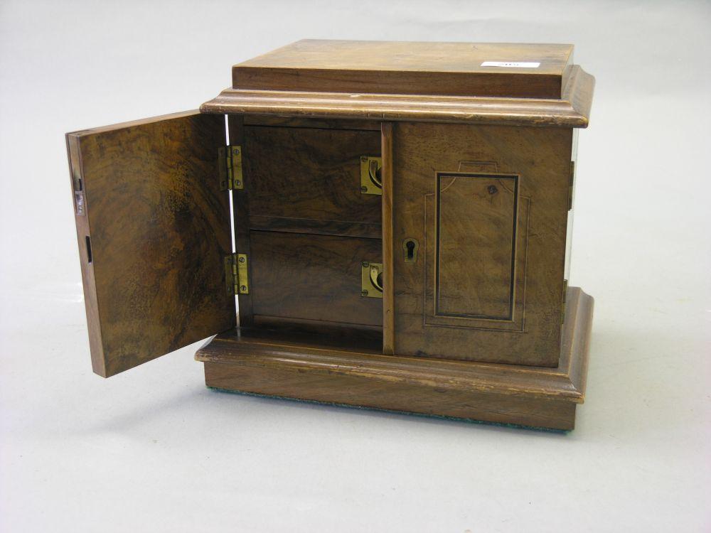 Appraisal: A Victorian walnut veneered cupboard pair of inlaid doors enclosing