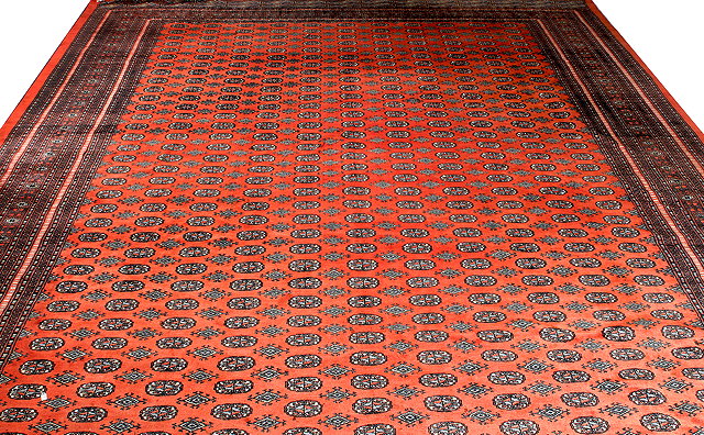 Appraisal: A MID TO LATE TH CENTURY PAKISTANI RED GROUND CARPET