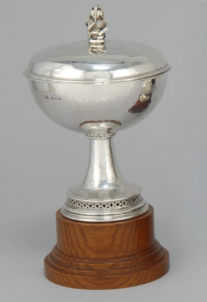 Appraisal: OMAR RAMSDEN SILVER COVERED CHALICE London Mounted on wooden base