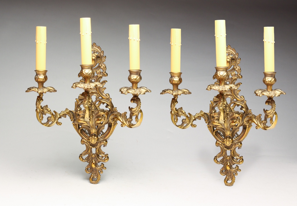 Appraisal: PAIR OF EUROPEAN THREE LIGHT BRASS SCONCES First half twentieth