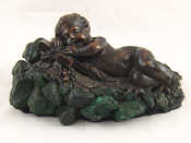 Appraisal: A Russian bronze of a baby resting asleep on a