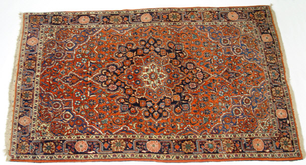 Appraisal: Rectangular red ground rug decorated with predominantly blue flowers approximately