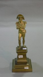 Appraisal: A gilded bronze figure of the young Napoleon standing on