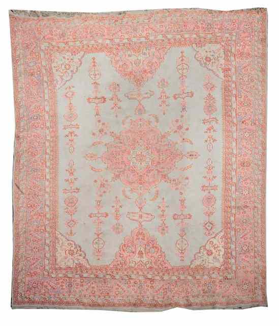 Appraisal: AN ANTIQUE TURKISH CARPET decorated with a central pink ground